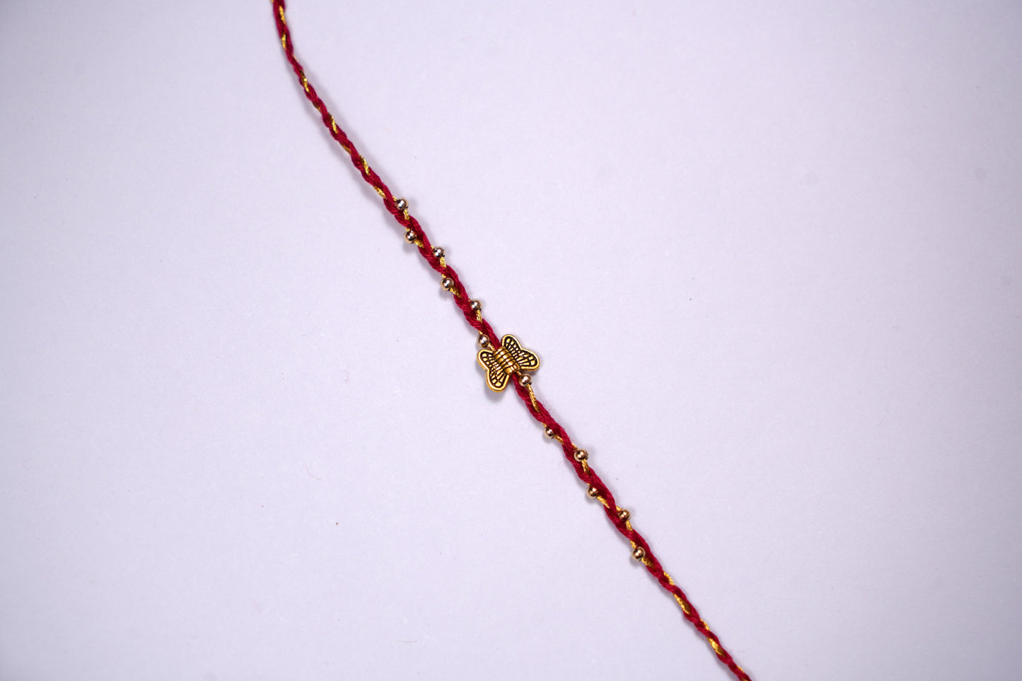 Golden Butterfly Rakhi with Red Golden Thread