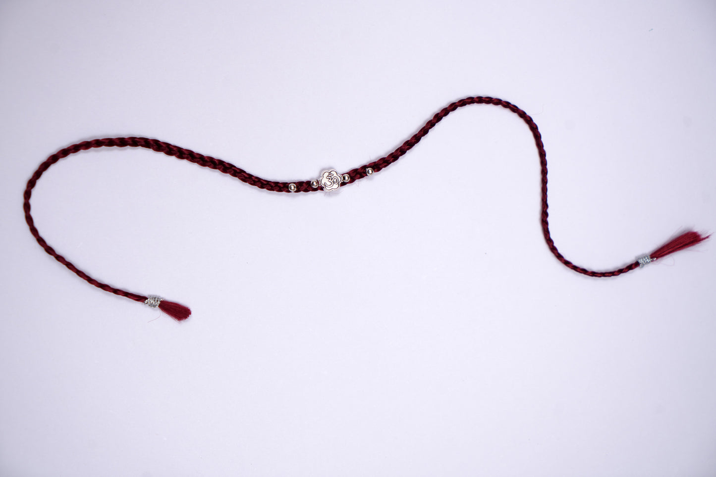 Maroon Braided Silk Thread Rakhi with Silver Om Charm