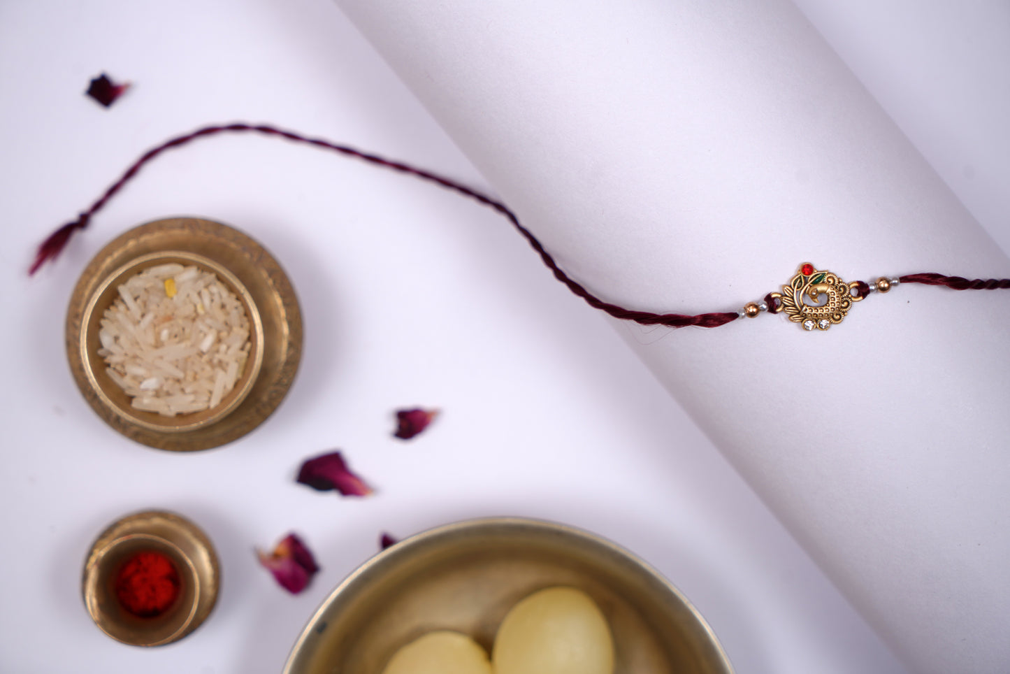 Maroon twisted Silk Thread Rakhi with Peacock Charm