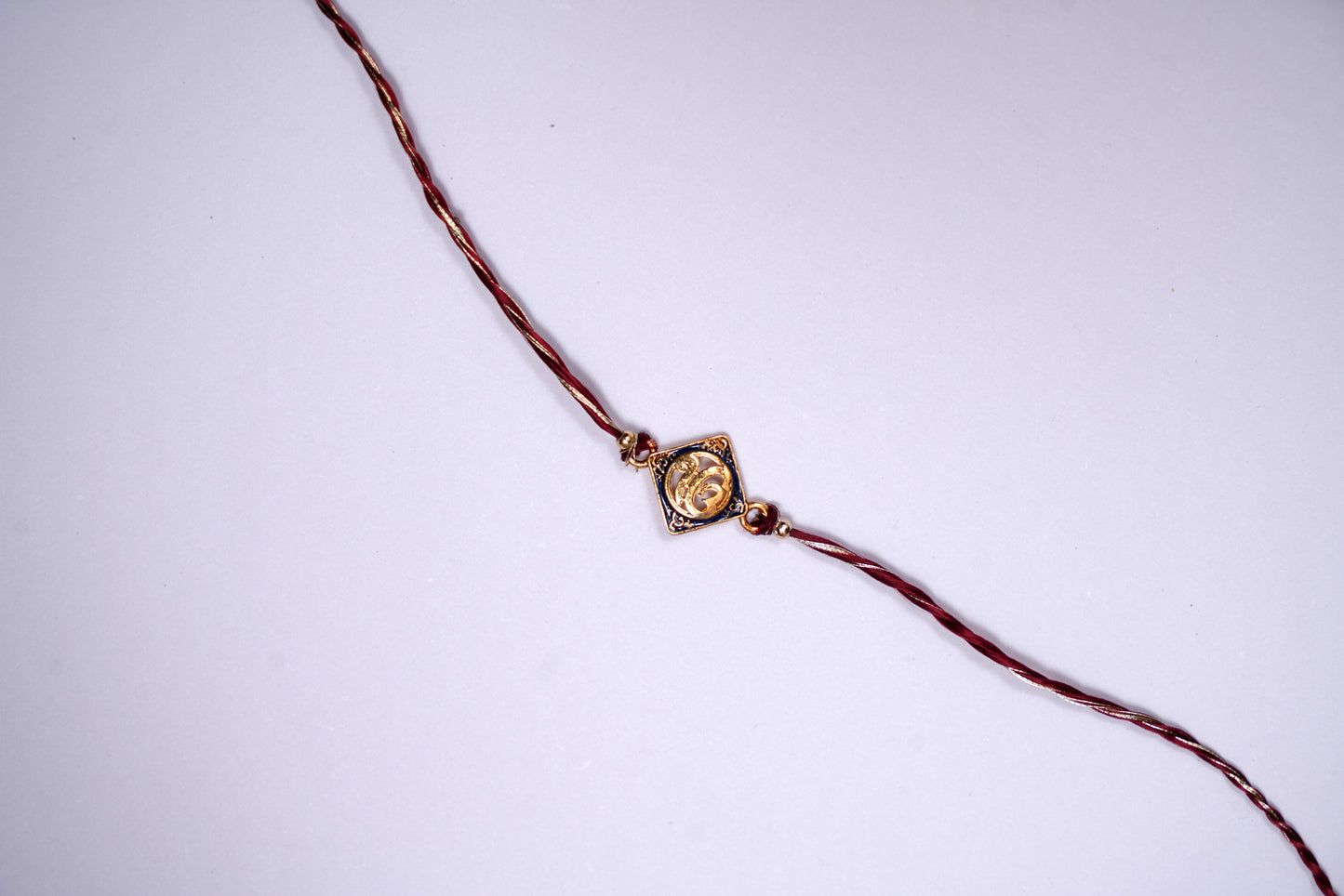 Golden Maroon twisted Silk Thread Rakhi with Ek Onkar Charm