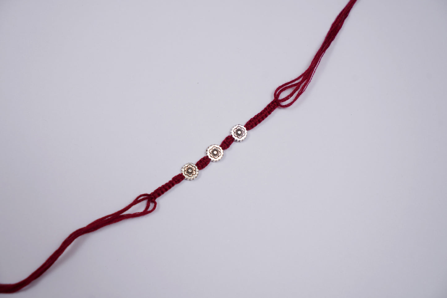 Silver Flower Rakhi with Braided Thread