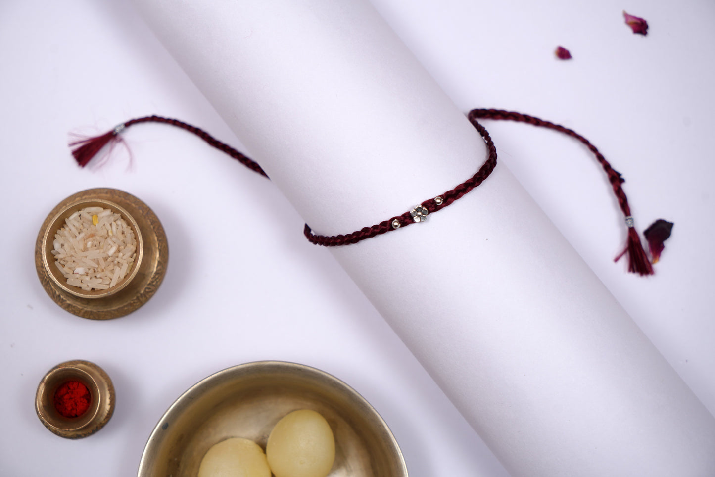 Maroon Braided Silk Thread Rakhi with Silver Floral Charm