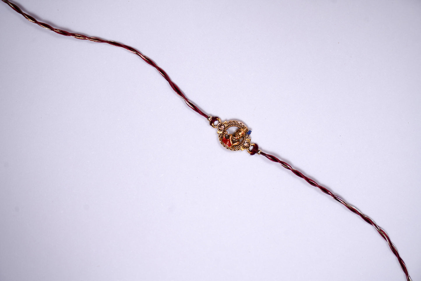 Golden Maroon twisted Silk Thread Rakhi with Kanha Charm