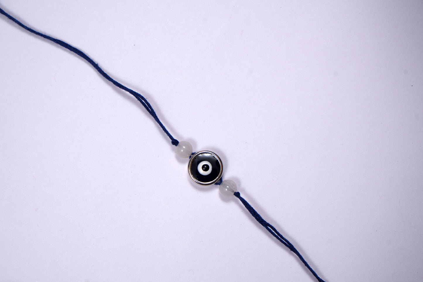 Blue Evil Eye Charm Rakhi on Blue Thread