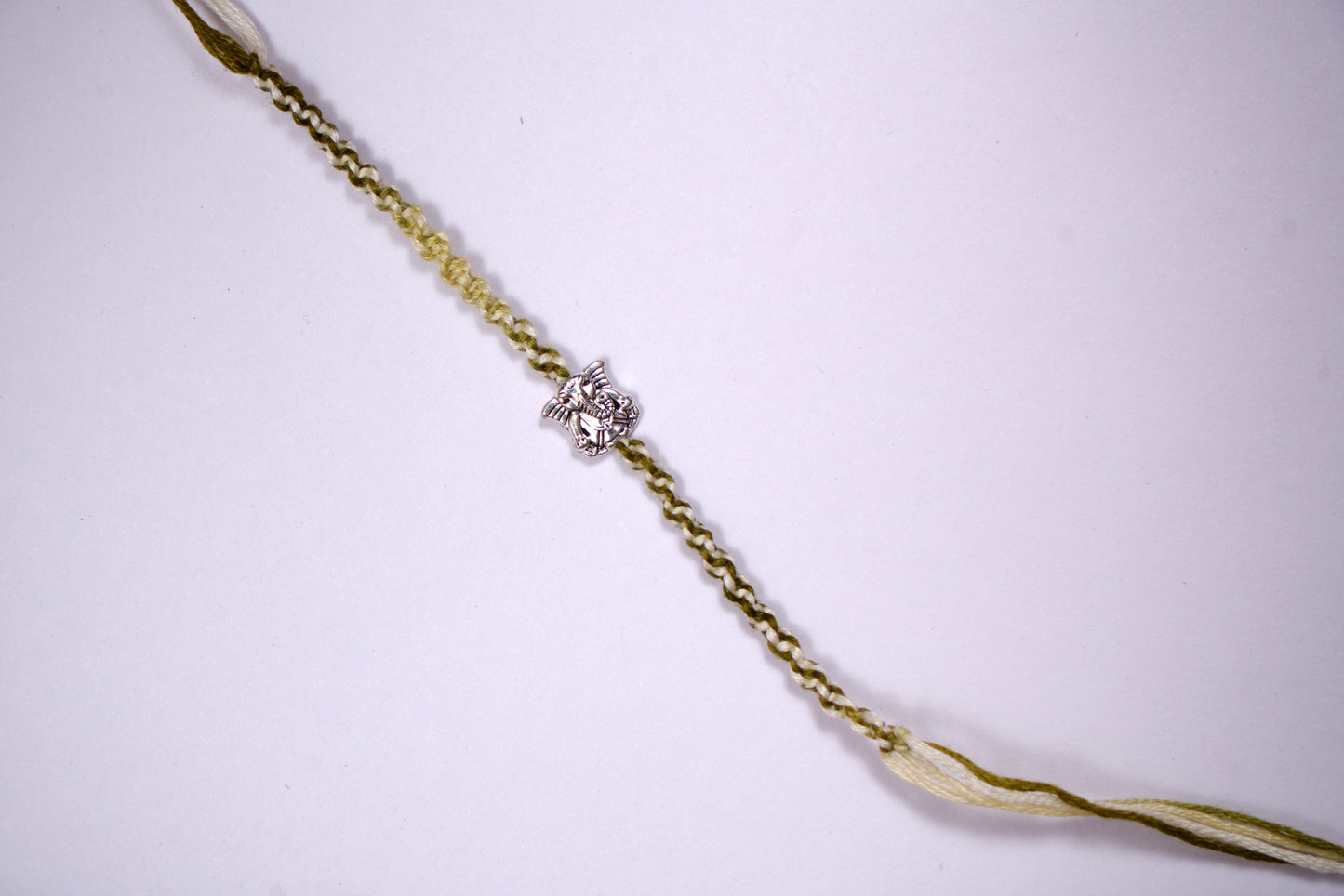 Braided Green Rakhi with Silver Lord Ganesha Charm