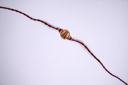 Maroon twisted Silk Thread Rakhi with Lord Ganesha Charm