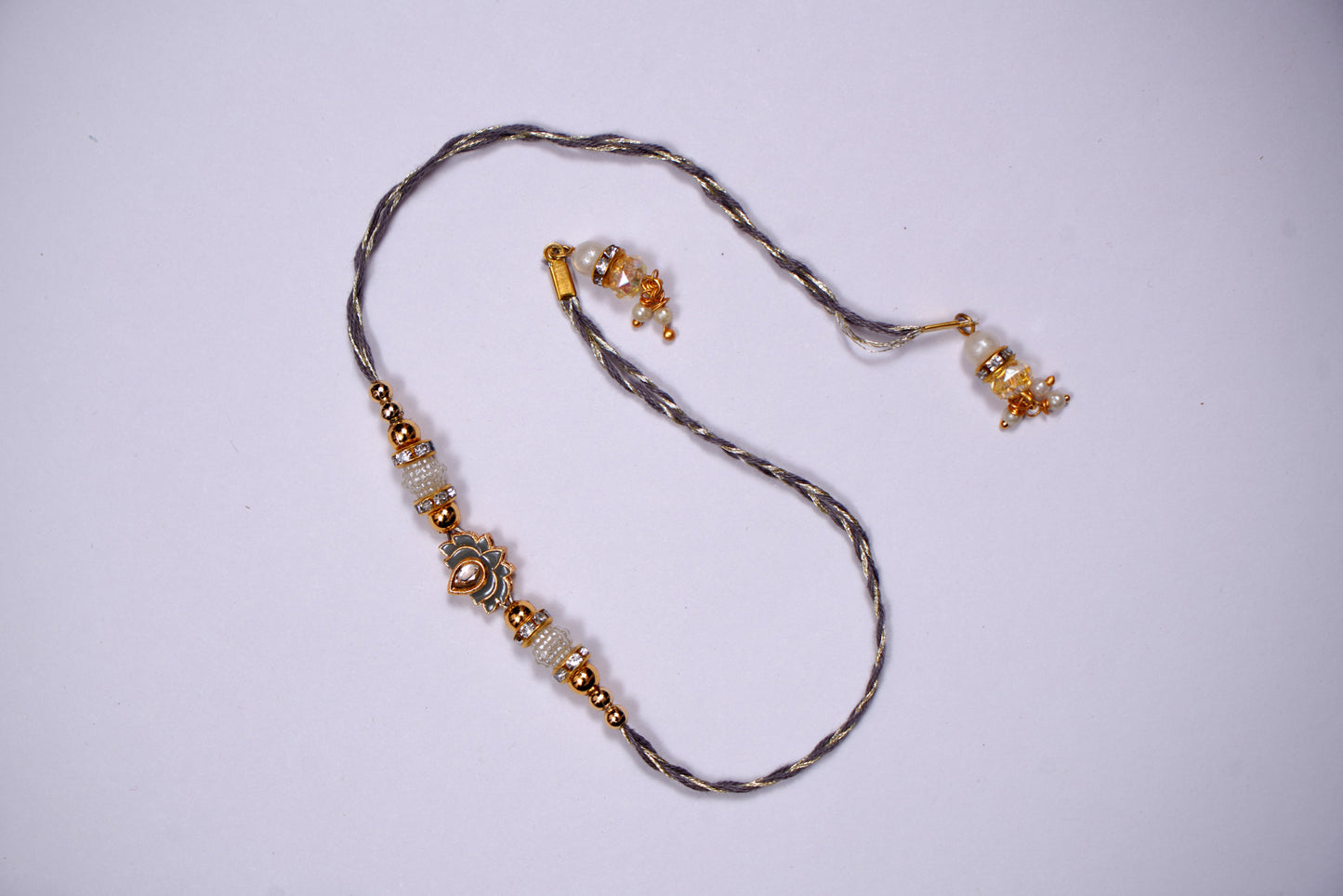 Grey Lotus Meenakari Motif Rakhi With Golden Grey Thread