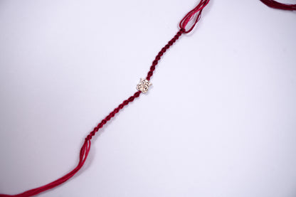 Braided Maroon Rakhi with Silver Lord Ganesha