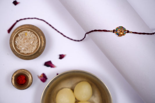 Maroon twisted Silk Thread Rakhi with Mor Charm