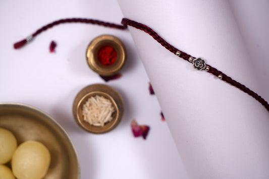 Maroon Braided Silk Thread Rakhi with Silver Om Charm