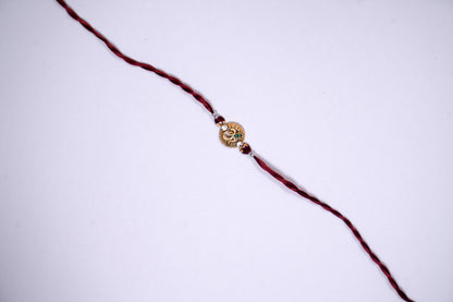 Maroon twisted Silk Thread Rakhi with Om Charm