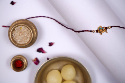Maroon twisted Silk Thread Rakhi with Mor Pankh Charm