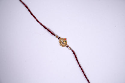 Maroon twisted Silk Thread Rakhi with Peacock Charm