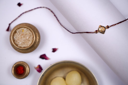 Golden Maroon twisted Silk Thread Rakhi with Ek Onkar Charm