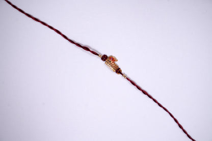 Maroon twisted Silk Thread Rakhi with Radha Krishna Charm