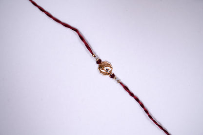 Maroon twisted Silk Thread Rakhi with White Mor Pankh Charm