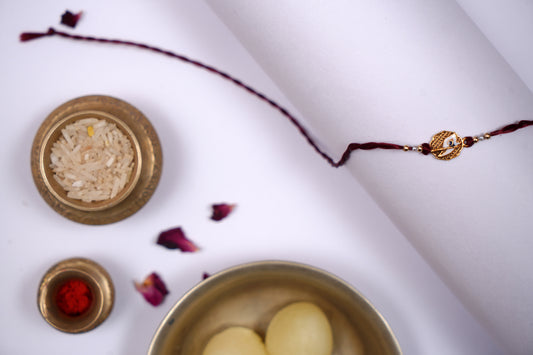 Maroon twisted Silk Thread Rakhi with White Mor Pankh Charm